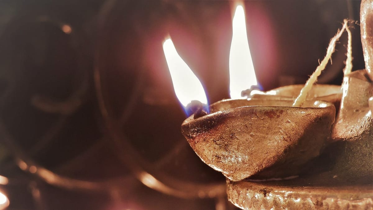 Rows of lit clay diya lamps arranged for Diwali
