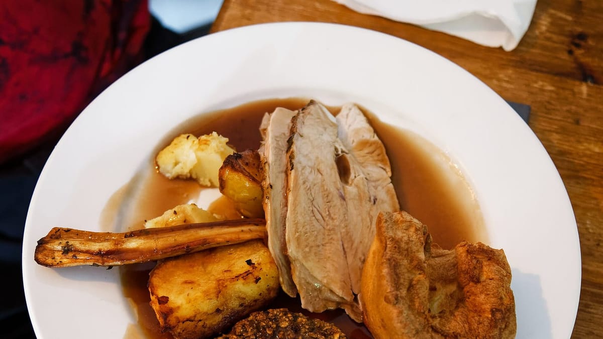 A roast turkey dinner laid out on the table for the holiday feast